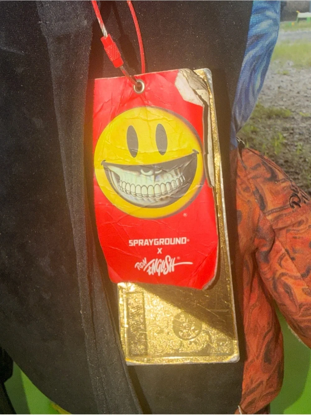 Sprayground Red Tag with Yellow Smiley and Gold Accent